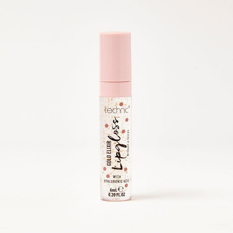 A gold elixir lip gloss in front of a white background.