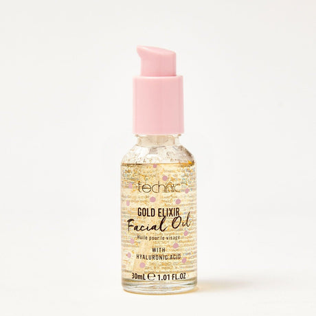 A gold elixir facial oil in front of a white background.