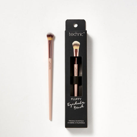 2 fluffy eyeshadow brushes on a white background. 1 is in its original packaging which is black and has an image of he brush on the front, and the other is out of the packaging.