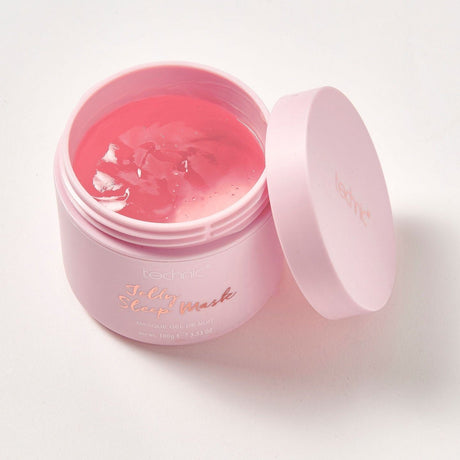 An opened jelly sleep mask on a white background. Its an overhead image and the lid is next to the product.