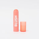 An opened blusher stick in the shade Peach Syrup on a white background.