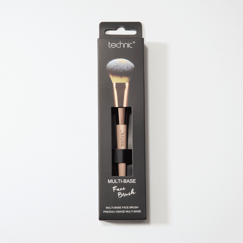 A multi-base face brush in its original black packaging on a white background.