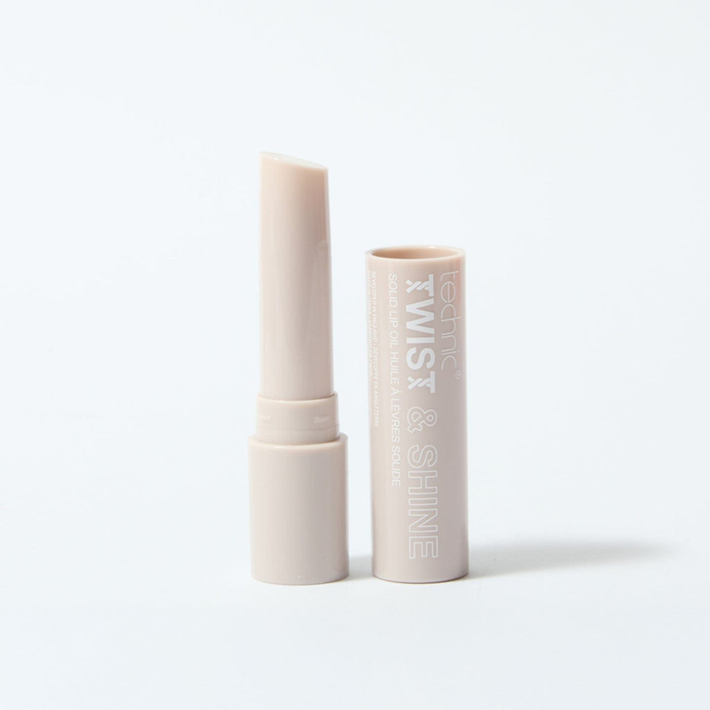 An opened twist and shine lip oil in the shade Clear Sparkle on a white background.