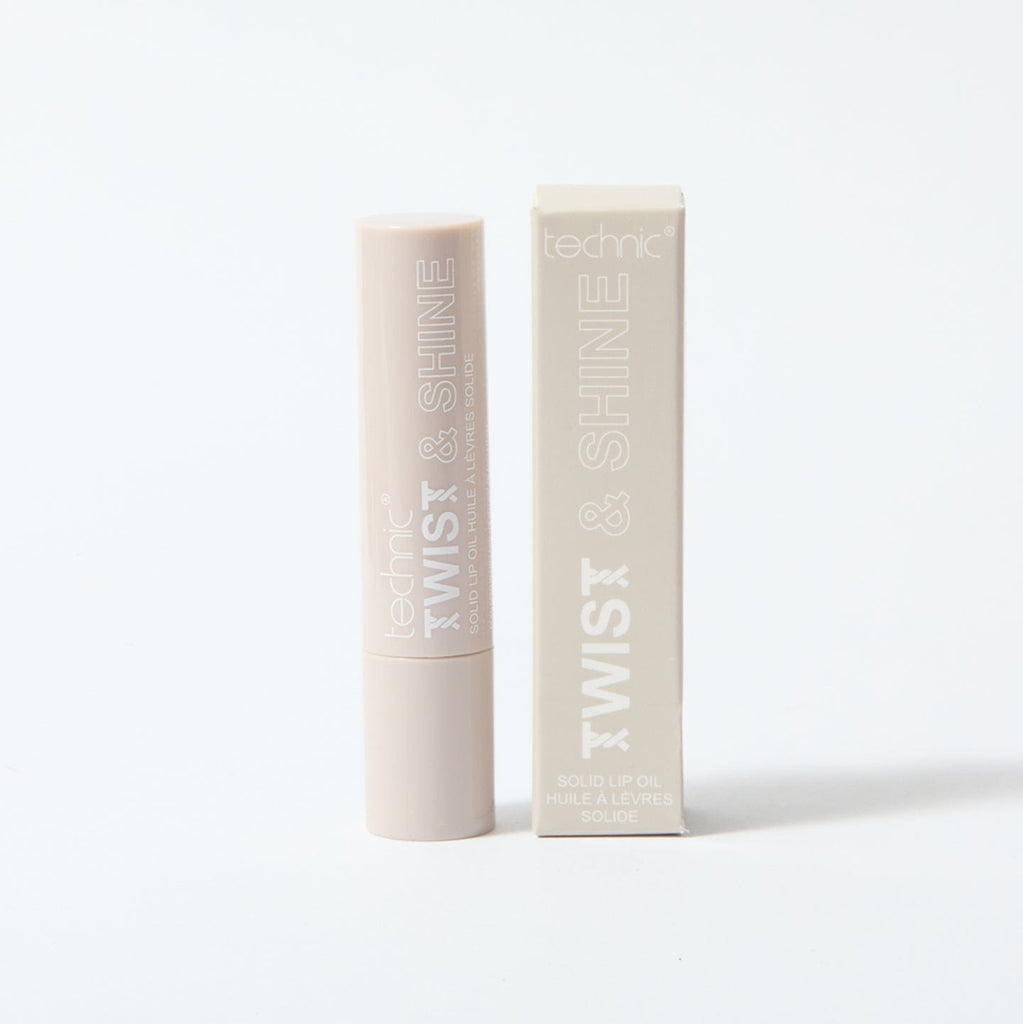 A twist and shine lip oil in the shade Clear Sparkle on a white background with the box packaging next to the product.