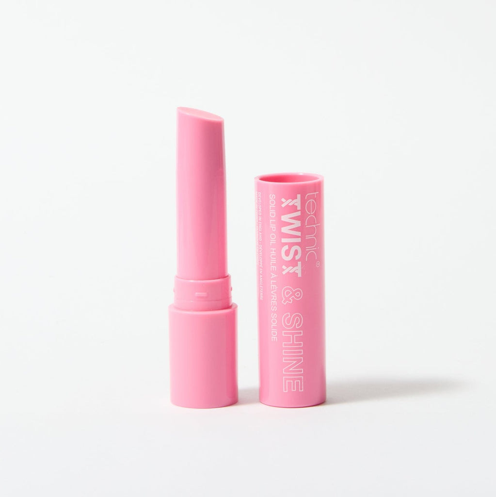 An opened twist and shine lip oil in the shade Pink Sparkle on a white background.