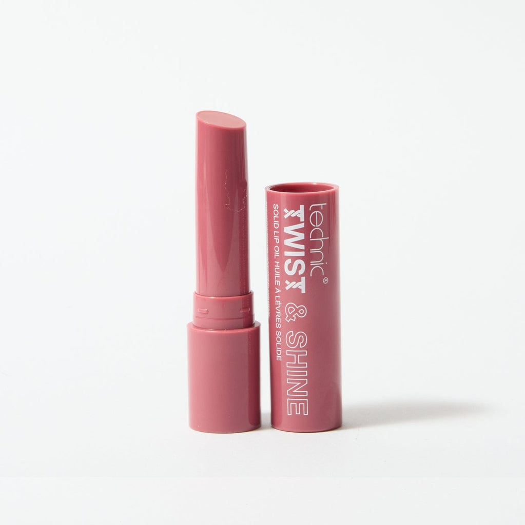 An opened twist and shine lip oil in the shade Pinky Nude on  white background.