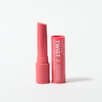 An opened twist and shine lip oil in the shade Strawberry Kiss on a white background. 