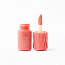 Peach whipped lip and cheek with applicator on a white background