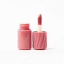 Pink whipped lip and cheek with applicator on a white background