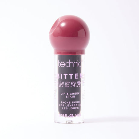 Technic Beauty Bitten by Cherry lip and cheek stain in a clear tube with a glossy dark cherry pink cap, shown on a white background.