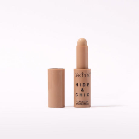 Technic Hide & Chic Concealer stick in a Porcelain shade, shown with its cap off next to the tube on a clean white background.