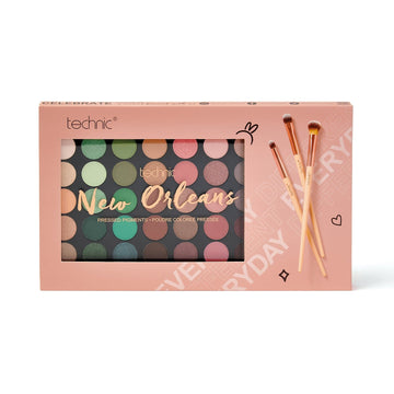 The new orleans giftset on a white background. The giftset packaging is pink with a cut out at the front so the palette is visible and images of the makeup brushes included next to the palette.