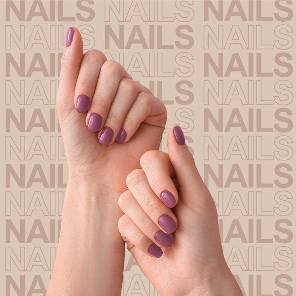 Models hands with nails painted purple.