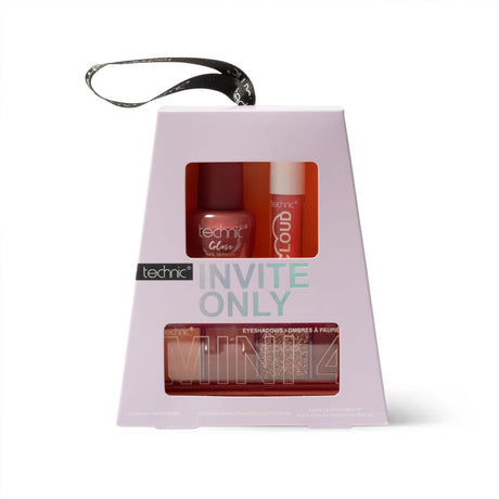 Technic 'Invite Only' cosmetics gift set in a light pink trapezoidal box with a black hanging loop, featuring a nail polish bottle, lip product, and eyeshadow palette visible through front windows.